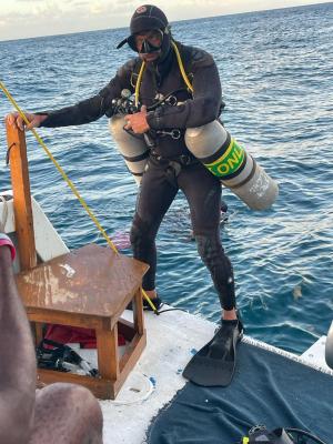 a person standing next to a body of water