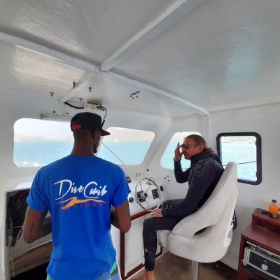 two crew members inside the boat wheelhouse