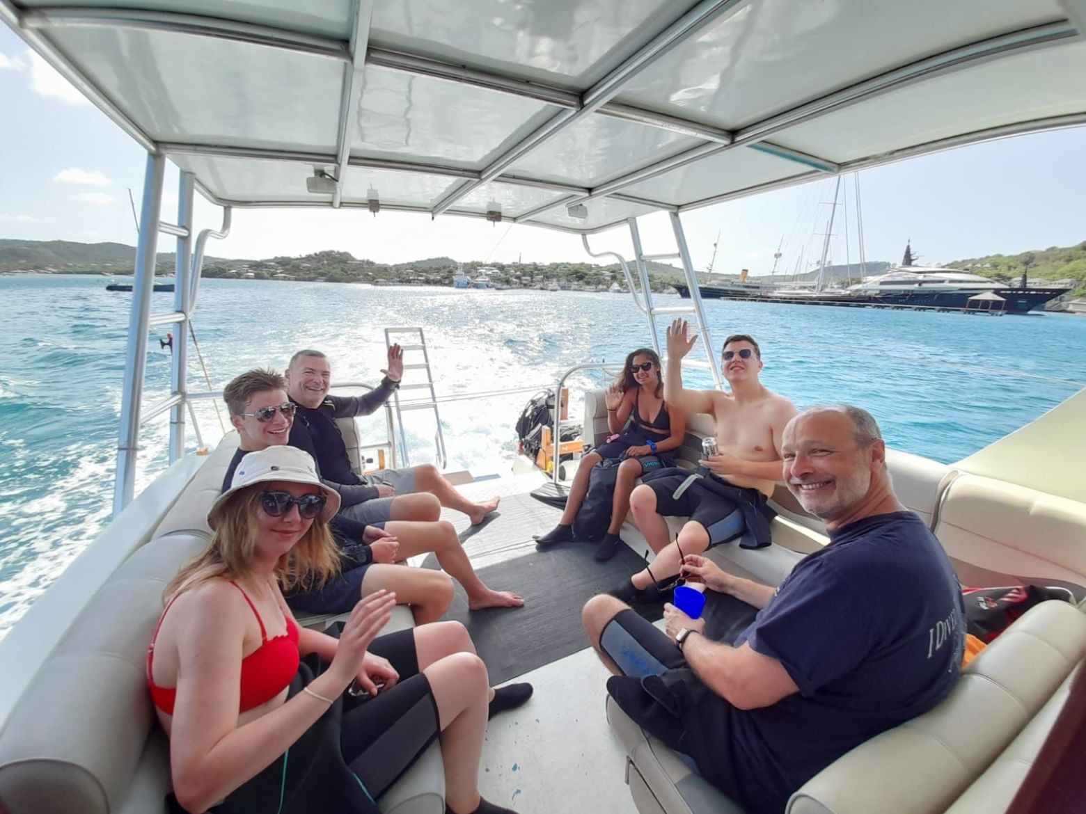 a group of people sitting in a boat on a body of water