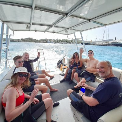 a group of people sitting in a boat on a body of water
