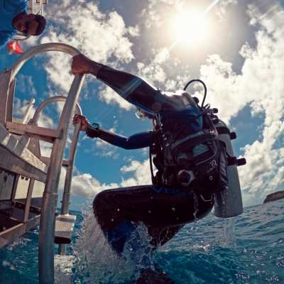 a scuba diver boarding the boat ladder