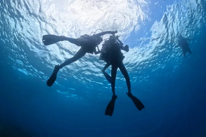 scuba divers practicing rescue techniques